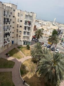 a view of a city with palm trees and buildings at Complexe la brise tour 8 appt 815 in La Goulette