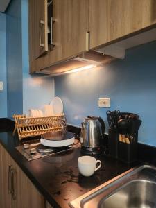 a kitchen with a sink and a counter top at 438 Shore Residences tower B - MOA in Sampong