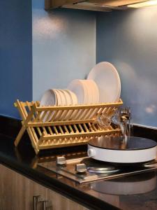 a dish rack with plates and plates on a kitchen counter at 438 Shore Residences tower B - MOA in Sampong +74 photos