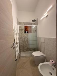 a bathroom with a toilet and a sink at Casa Vicolo in Peccioli +11 photos