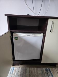 a dishwasher in a cabinet with a white appliance at Vila Mihnea in Moieciu de Jos