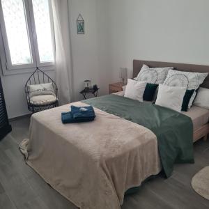 a bedroom with a large bed and a chair at Sunny house in Pierrefeu-du-Var