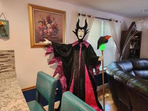a clown costume in a living room next to a couch at Old Salem House 15 mins from downtown Salem in Peabody