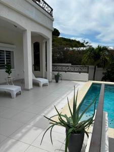a patio with a swimming pool and a house at Luxury 3BR Villa Belair in Philipsburg