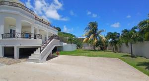 a large white house with stairs and a yard at Luxury 3BR Villa Belair in Philipsburg