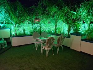 a table and chairs in a room with green plants at Luxury Private Suite in Rhodes Town