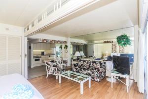 a living room with a couch and a table at Ilikai Tower 1842 in Honolulu