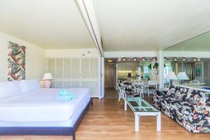 a bedroom with a bed and a living room at Ilikai Tower 1842 in Honolulu