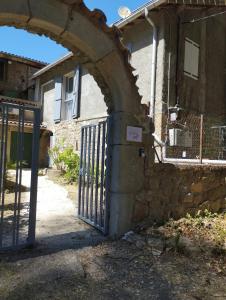 an entrance to a stone building with a gate at L'Uzerois in Uzer