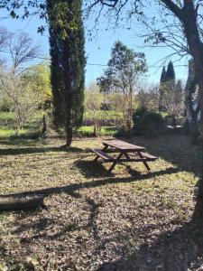 a picnic table sitting in the middle of a park at L'Uzerois in Uzer