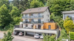 an aerial view of a house with cars parked in a parking lot at Lake Lodge Ossiacher See in Annenheim