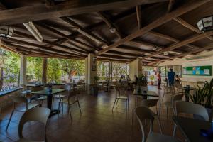 a restaurant with wooden ceilings and tables and chairs at Camping Villaggio Egad in Favignana