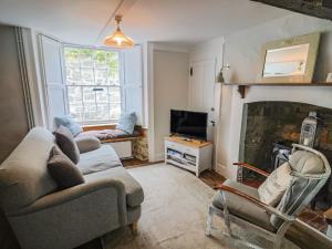 a living room with a couch and a fireplace at The Nest in Lyme Regis
