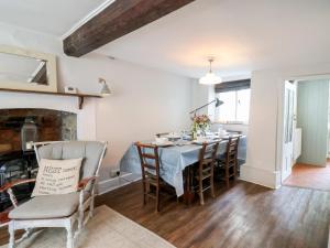 a kitchen and dining room with a table and chairs at The Nest in Lyme Regis