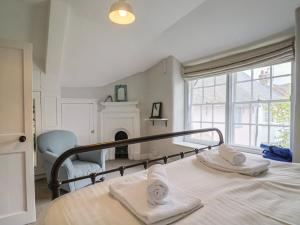 a bedroom with a bed with towels on it at The Nest in Lyme Regis