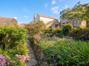 a garden in front of a house with flowers at The Nest in Lyme Regis