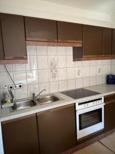 a small kitchen with a sink and a stove at Haus Brandner Judenburg in Judenburg