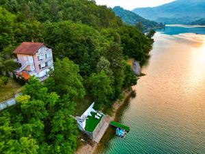 an aerial view of a house on the shore of a river at Golden Lake House in Konjic