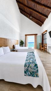 a bedroom with two beds and a view of the ocean at “Magic Sunrise at Cancun” in Cancún +71 photos