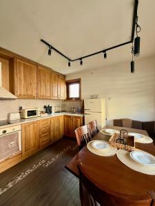 a kitchen with a table with two plates on it at Krisiya's Apartment in Bansko