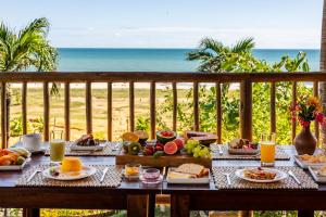 a breakfast table with a view of the beach at Hurricane Jeri in Jericoacoara