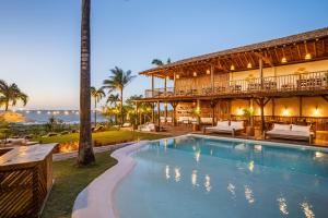 a resort with a swimming pool in front of a building at Hurricane Jeri in Jericoacoara
