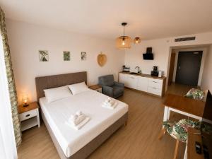 a bedroom with a bed and a living room at AMD Apartamenty Ustka *** in Ustka