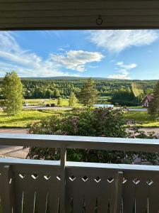 a view from the porch of a house with a white fence at Villa Älva i Sälen in Sälen