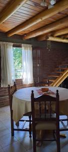 a dining room with a table and some chairs at TIERRA SERRANA CABAÑAS s in Villa Anizacate