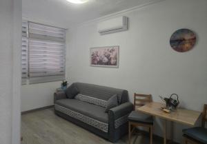 a living room with a couch and a table at Medano Time in El Médano