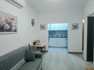 a living room with a couch and a table at Medano Time in El Médano +20 photos