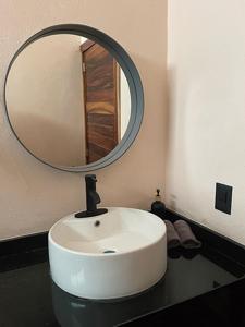 a bathroom with a white sink and a mirror at Soulchitlán in Suchitlán