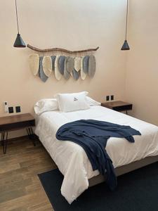 a bedroom with a bed with two tables and two lights at Soulchitlán in Suchitlán
