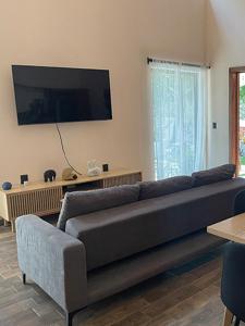 a living room with a couch and a flat screen tv at Soulchitlán in Suchitlán