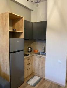 a kitchen with a stainless steel refrigerator and wooden cabinets at Kechi home 6 in Tsaghkadzor