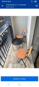 two chairs and a table on a balcony at Kechi home 6 in Tsaghkadzor