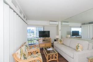 a living room with a couch and a tv at Ilikai Tower 633 in Honolulu