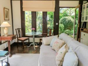 a living room with a couch and a table at The Barn at Frog Pond Farm in Salisbury +14 photos