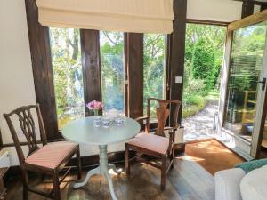 a dining room with a table and chairs and a window at The Barn at Frog Pond Farm in Salisbury