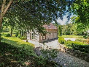 an exterior view of a house with a garden at The Barn at Frog Pond Farm in Salisbury