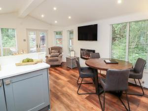 una cucina e un soggiorno con tavolo e sedie di Willows Lodge a Windermere