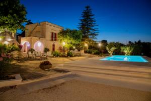 a house with a swimming pool at night at Masseria Trulli Bruni in Locorotondo