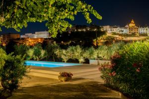 a view of a swimming pool at night at Masseria Trulli Bruni in Locorotondo