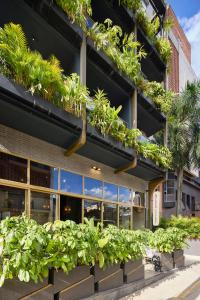 a building with plants on the side of it at Golden Valley Hotel in Medellín