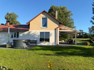 a house with a bench in the yard at Dizrobeznieki in Veldze +11 photos