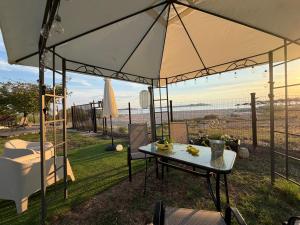 a tent with a table and chairs in a yard at Athos Sea Villa in Ouranoupoli +22 photos