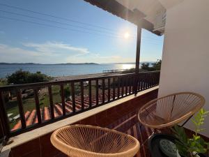 a balcony with two chairs and a view of the ocean at Athos Sea Villa in Ouranoupoli