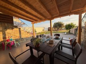 a wooden table and chairs on a patio at Athos Sea Villa in Ouranoupoli