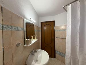 a bathroom with a sink and a toilet and a mirror at Athos Sea Villa in Ouranoupoli