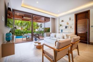 a living room with a white couch and a table at Quiya Beach Residences in Cruz de Huanacaxtle